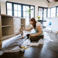 young woman repairing an old furniture and enjoying at home - home decoration stock pictures, royalty-free photos & images