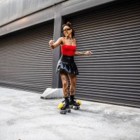 young woman rollerskating in urban area - fashion photos et images de collection