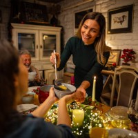 young woman serving a soup during the christmas dinner - food stock pictures, royalty-free photos & images