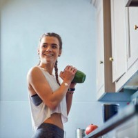 young woman shaking juicer at kitchen counter - food stock pictures, royalty-free photos & images
