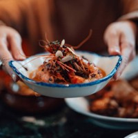 young woman sharing food with friends at restaurant - food stock pictures, royalty-free photos & images