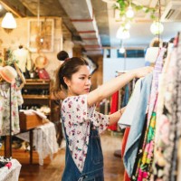 young woman shopping in a vintage clothing store - fashion stock pictures, royalty-free photos & images