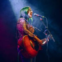 young woman singer under the spotlight - concert stock pictures, royalty-free photos & images