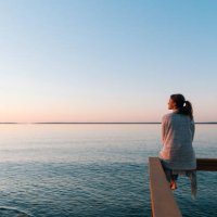 young woman sitting on edge looks out at view - travel stock pictures, royalty-free photos & images