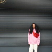 young woman standing casually against graphic background - fashion stock pictures, royalty-free photos & images