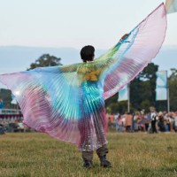 young woman standing with fanned out cape - concert stock-fotos und bilder