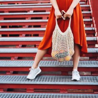 young woman standing with shopping net bag. - fashion stock pictures, royalty-free photos & images
