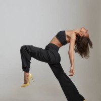 young woman stepping as if dancing. - fashion stock pictures, royalty-free photos & images