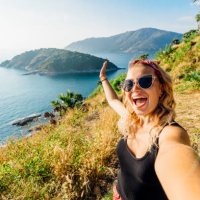 young woman takes selfie, on hillside above sea - travel stock pictures, royalty-free photos & images