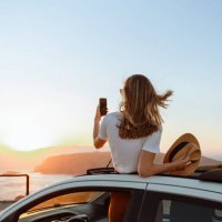 young woman taking a photo of the sunset - travel stock pictures, royalty-free photos & images