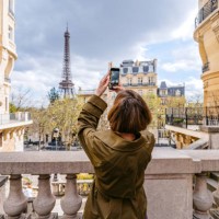 young woman taking pictures of an eiffel tower in paris in france - travel stock pictures, royalty-free photos & images