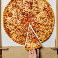 young woman taking slice of pizza, overhead view - junk food stock pictures, royalty-free photos & images