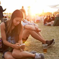 young woman tjecking smartphone at festival - concert stock pictures, royalty-free photos & images