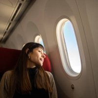 young woman traveling by plane looking out the window - travel stock pictures, royalty-free photos & images