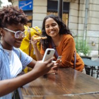 young woman using e-commerce services on a city break - junk food stock pictures, royalty-free photos & images