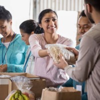 young woman volunteering in food bank - food stock pictures, royalty-free photos & images