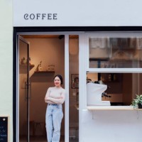 young woman waitress at the door of the cafe - junk food stock pictures, royalty-free photos & images