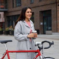 young woman walking with bicycle - junk food stock pictures, royalty-free photos & images