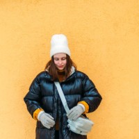 young woman while standing against yellow wall - fashion stock pictures, royalty-free photos & images