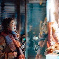 young woman window shopping in the city at night - fashion stock pictures, royalty-free photos & images