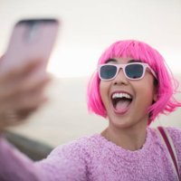 young woman with pink hair taking a selfie - hairstyle stock pictures, royalty-free photos & images