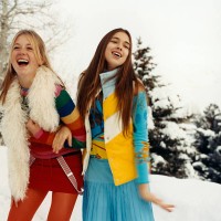 young women arm in arm in snow - fashion stock pictures, royalty-free photos & images