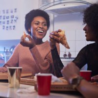 young women having party in the kitchen and eating pizza - junk food stock pictures, royalty-free photos & images