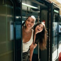 young women looking out of the train door - travel stock pictures, royalty-free photos & images