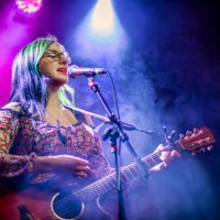 your woman singer and guitarist performing live concert - concert stock pictures, royalty-free photos & images