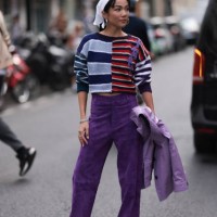 Yoyo Cao is seen outside Dries Van Noten show wearing white head piece, silver hoop earrings, blue, lilac and red striped sweater, lilac colored pair...