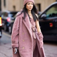 Yoyo Cao is seen wearing a pink hat, a matching pink long dress with a cross-body trail and a pink teddy long coat outside the Max Mara show during...