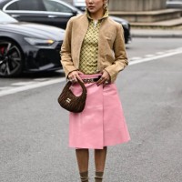Yoyo Cao is seen wearing a tan Miu Miu jacket, plaid shirt, pink Miu Miu skirt, brown Miu Miu bag and brown heels with tan socks outside the Miu Miu...