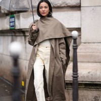 Yoyo Cao wears a gray trench long coat , beige pants , yellow pointed shoes , outside Hermes, during the Womenswear Fall/Winter 2024/2025 as part of...