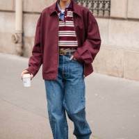 Yoyo Cao wears brown and white Miu Miu polo neck top, blue checked shirt, burgundy Miu Miu jacket, blue jeans, brown loafers, brown belt, outside Miu...