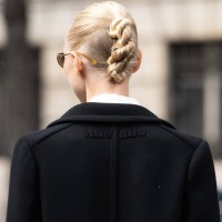 Yulia Lobova - Harfouch wears a Miu Miu coat and a twist in her hair outside the Miu Miu show during Womenswear Spring/Summer 2025 as part of Paris...