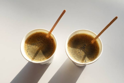2 boxes of paper disposable cups without lid on the table in the cafe. coffee to go with the sticks . morning. coffee for breakfast. 2 cups of coffee. the shadows of the cups. - junk food stock pictures, royalty-free photos &