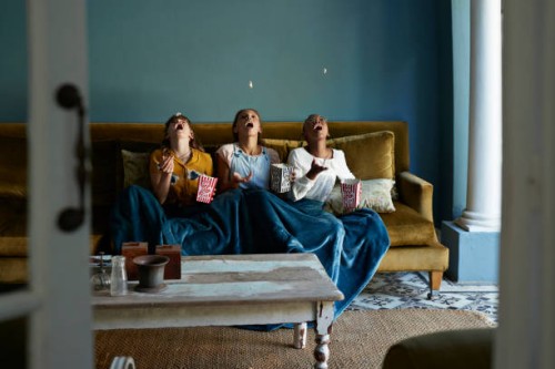 3 friends catching popcorn with the mouth - food stock pictures, royalty-free photos & images
