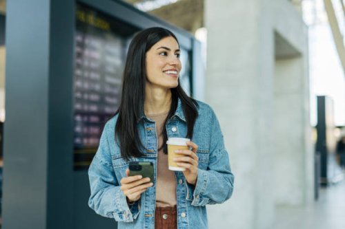 a adult cheerful woman at the airport or train station. - junk food stock pictures, royalty-free photos & images