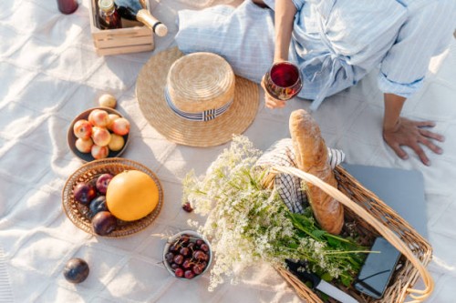 a beautiful young woman is having a good time on the beach on a picnic. a sunny summer day. - fashion stock pictures, royalty-free photos & images