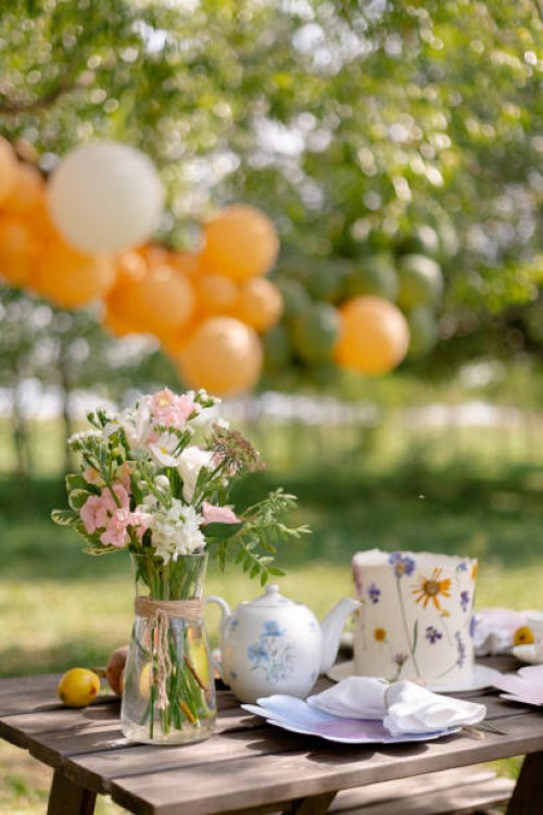 a bouquet and cake on the table outdoors - garden decoration stock pictures, royalty-free photos & images