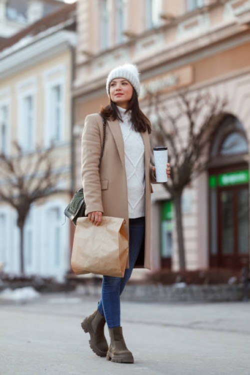 a caucasian woman strolls along a city street - fashion stock pictures, royalty-free photos & images