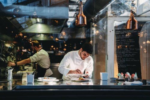 a chef is cooking in his restaurant's kitchen - food stock pictures, royalty-free photos & images