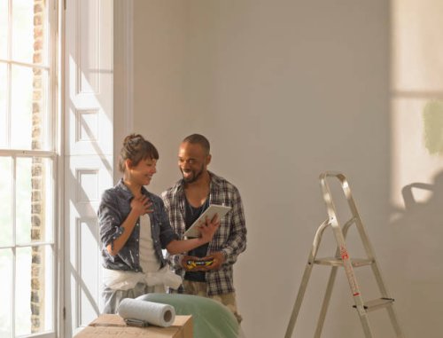 a couple discussing diy looking at an tablet computer - home decoration stock pictures, royalty-free photos & images