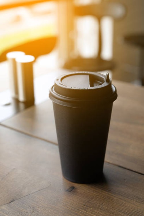 a cup of coffee on the wooden bar. coffee break. a disposable cup to go. tinted photo. - junk food stock pictures, royalty-free photos & images