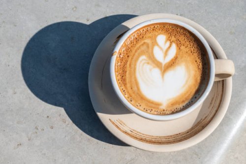 a cup of latte coffee on table. - coffee stock pictures, royalty-free photos & images