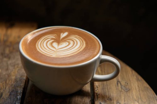 a cup of latte on wooden table - coffee stock pictures, royalty-free photos & images