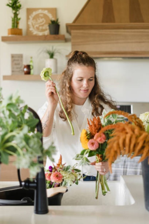 a cut flower farmer arranging a white flower in a bouquet over h - garden decoration stock pictures, royalty-free photos & images