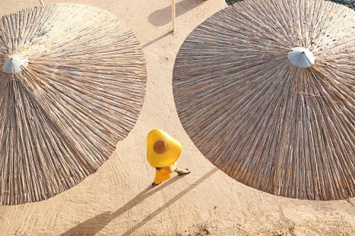 a fashionable woman walks along the beach - fashion stock-fotos und bilder