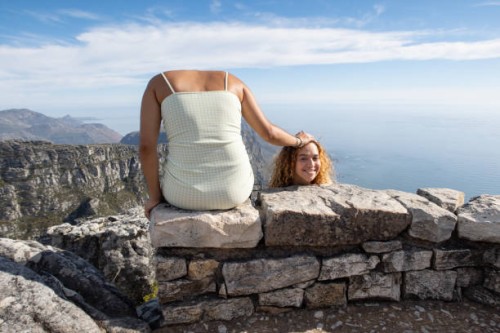 a fun picture of girl holding her head next to her - travel stock pictures, royalty-free photos & images