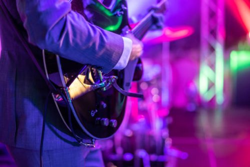 a guitarist plays at a rock or rock n roll concert. - concert stock pictures, royalty-free photos & images